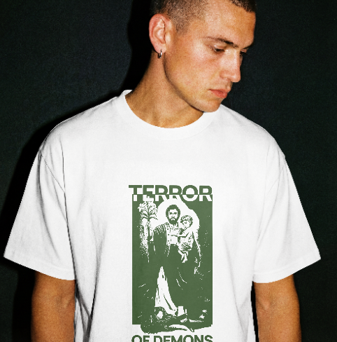 Person wearing a white t-shirt with a graphic design and text on a black background