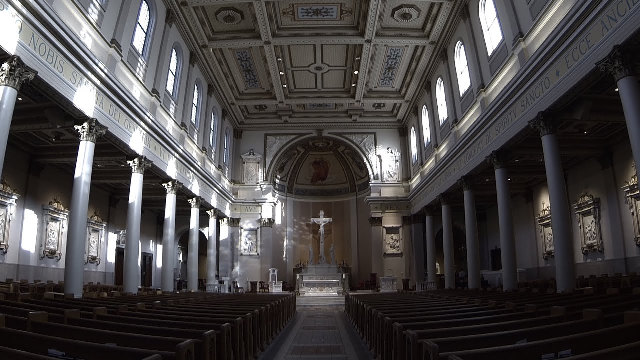Large, ornate cathedral interior with high ceilings and rows of pews.