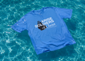 Blue t-shirt with 'Arise Soldiers of Christ' text on a pool surface